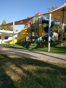 a playground with a slide in a park at Idan Lodge in the Arava in Paran