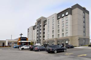 a parking lot with cars parked in front of a building at Staybridge Suites - Waterloo - St. Jacobs Area in Waterloo