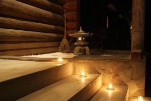 a room with candles on the steps in a building at Double Black Hotel in Hakuba