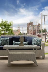 a gray bench with pillows on it on a street at Belle Louise Historic Bed & Breakfast in Paducah