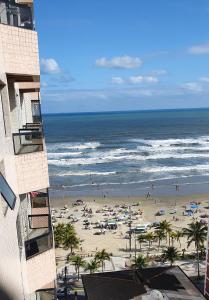 a view of a beach with people and the ocean at Apartamento Praia Grande na Tupi Frente Mar in Praia Grande