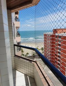 a balcony with a view of the ocean from a building at Apartamento Praia Grande na Tupi Frente Mar in Praia Grande