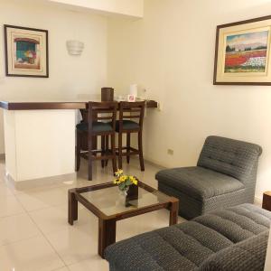 a living room with a table and a chair at Hotel Boulevard in Lima