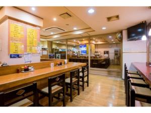a restaurant with a long bar with chairs and a counter at Hotel Taisei Annex - Vacation STAY 05217v in Kagoshima
