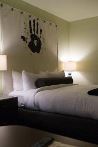 a bedroom with a bed with a handprint on the wall at Acme Hotel Company Chicago in Chicago