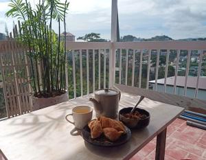 a table with a plate of food and a cup of coffee at Forelsket 2 in Da Lat