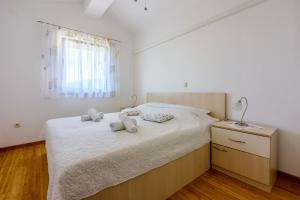 Posteľ alebo postele v izbe v ubytovaní Apartments Marissimo
