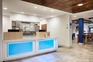 a lobby with a counter with two blue windows at Holiday Inn Express Hotel & Suites Salem, an IHG Hotel in Salem