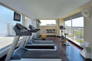 a gym with tread machines and a large window at Radisson Hotel Agra in Agra