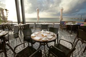 a dining area with tables, chairs and umbrellas at Grand Hyatt Playa del Carmen Resort in Playa del Carmen