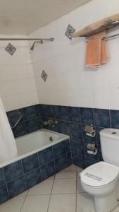 a bathroom with a toilet and a bath tub at Hotel De Talavera in Puebla