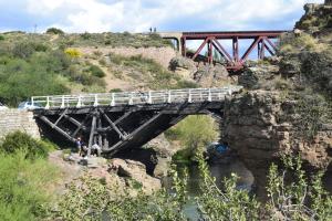 a bridge over a river with people standing on it at Montalto in Dina Huapi +19 photos