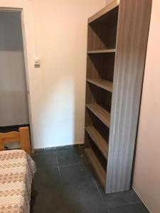 a bedroom with a book shelf next to a bed at Pousada Fran in Sao Paulo