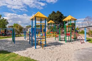 a playground with colorful equipment in a park at Discovery Parks - Melbourne in Braybrook