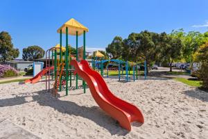 a playground with a slide in the sand at Discovery Parks - Melbourne in Braybrook