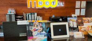 a desk with a computer on top of it at Mood Hotel in Skudai