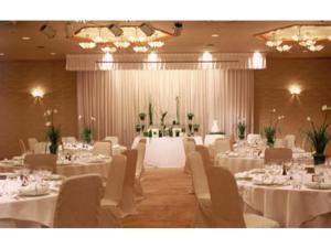 a banquet hall with white tables and white chairs at Shobara Grand Hotel - Vacation STAY 06902v in Shōbara