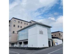 a large white building in front of a building at Shobara Grand Hotel - Vacation STAY 06902v in Shōbara +14 photos