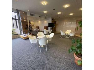 a waiting room with white chairs and a table at Shobara Grand Hotel - Vacation STAY 06883v in Shōbara +12 photos