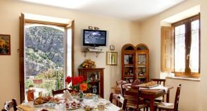 a dining room with a table and a large window at Il Belvedere in Civita