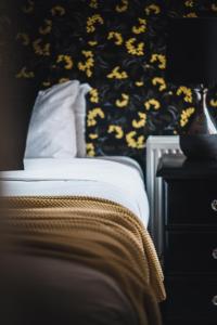 a bedroom with a bed with a black and yellow wallpaper at Wattle Terrace in Castlemaine