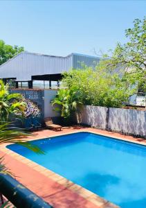 a large blue swimming pool on a patio at Hostel Park Iguazu in Puerto Iguazú