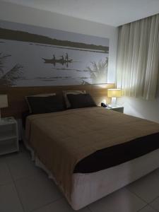 En eller flere senge i et værelse på Apartamento quarto e sala com varanda no ILOA Residence a 10 Km da Praia do Frances e 12 Km da Praia do Gunga