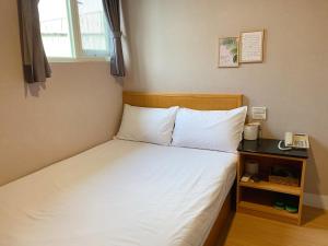 Postel nebo postele na pokoji v ubytování XDZ Hotel