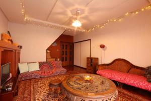 a living room with a couch and a table at Shanti House Sakaiminato in Sakaiminato