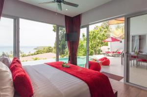 a bedroom with a large bed and a large window at Eranda Pool Spa Villa, Chaweng Koh Samui- SHA Extra Plus in Chaweng