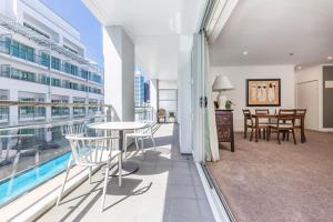 a balcony with a table and chairs in a building at QV Spacious Apt on the Wharf with Wifi (797) in Auckland