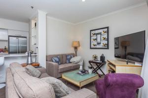 a living room with two couches and a tv at QV Spacious Apt on the Wharf with Wifi (797) in Auckland