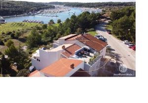 an aerial view of a large white house with a harbor at Apartments Bonvenon2Pula in Pula