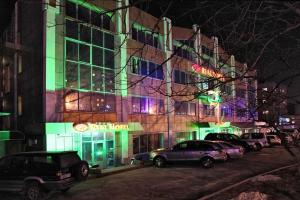 a building with cars parked in front of it at night at Hotel Rial in Vladivostok