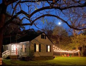 a house with christmas lights on a yard at night at Rappahannock River Cottage Near I-95! in Fredericksburg