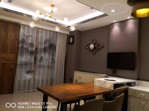 a dining room with a table and a television at Jiji Wu Homestay in Jiji