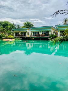 a house with blue water in front of it at Lake Terrace Resort in Langu