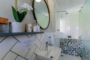 a bathroom with a sink and a mirror at Wildlife Retreat on a Wine-Farm in Stellenbosch +14 photos