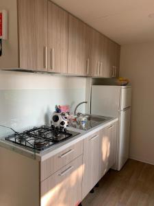 a kitchen with a stove top oven next to a refrigerator at Fornella Camping & Wellness family resort in San Felice del Benaco