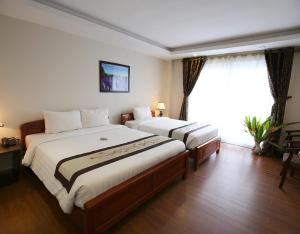Cama o camas de una habitación en Cosiana Sapa Hotel