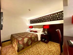 En eller flere senger på et rom på Hotel Metropole