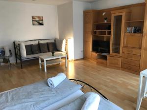 a living room with a couch and a tv at Apartment 2 Zimmer in Miltenberg