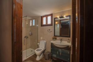 a bathroom with a toilet and a sink and a shower at Villa Arokaria in Tsilivi +7 photos