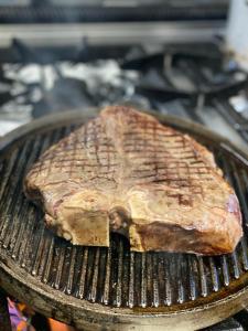 a piece of meat cooking on a grill at Albergo Ristorante Pizzeria Bellavista in Carenno