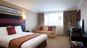 
a hotel room with a large bed and a large window at Crowne Plaza Birmingham NEC, an IHG Hotel in Bickenhill
