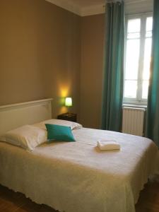 a bedroom with a bed with two towels on it at Auberge de la Cauquiere in Le Beausset