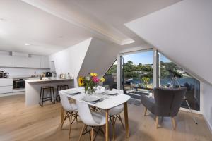 a kitchen and dining room with a table and chairs at Fowey Penthouse, Fowey in Fowey