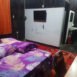 Voodi või voodid majutusasutuse Mimi Guest House Syariah Pangkalan bun toas