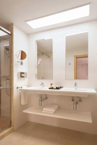 a bathroom with a sink and a mirror at Riu La Mola in Playa Migjorn