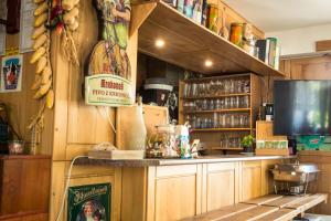 a bar with wooden cabinets and a sign on the wall at Pension U Pece in Pec pod Sněžkou